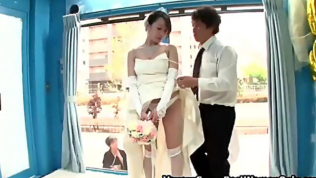 Asian bride in wedding gown gets naked and fucked through glass walls