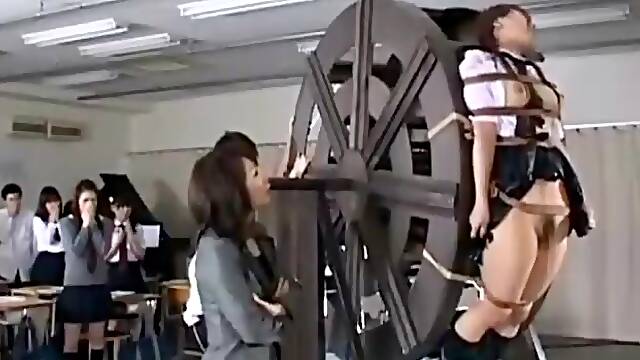 Japanese schoolgirls punished on waterwheel