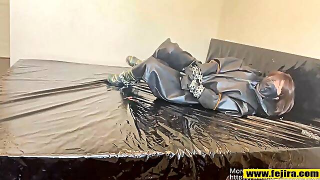 Fejira com Wearing heavy latex clothing tied to iron chains orgasm